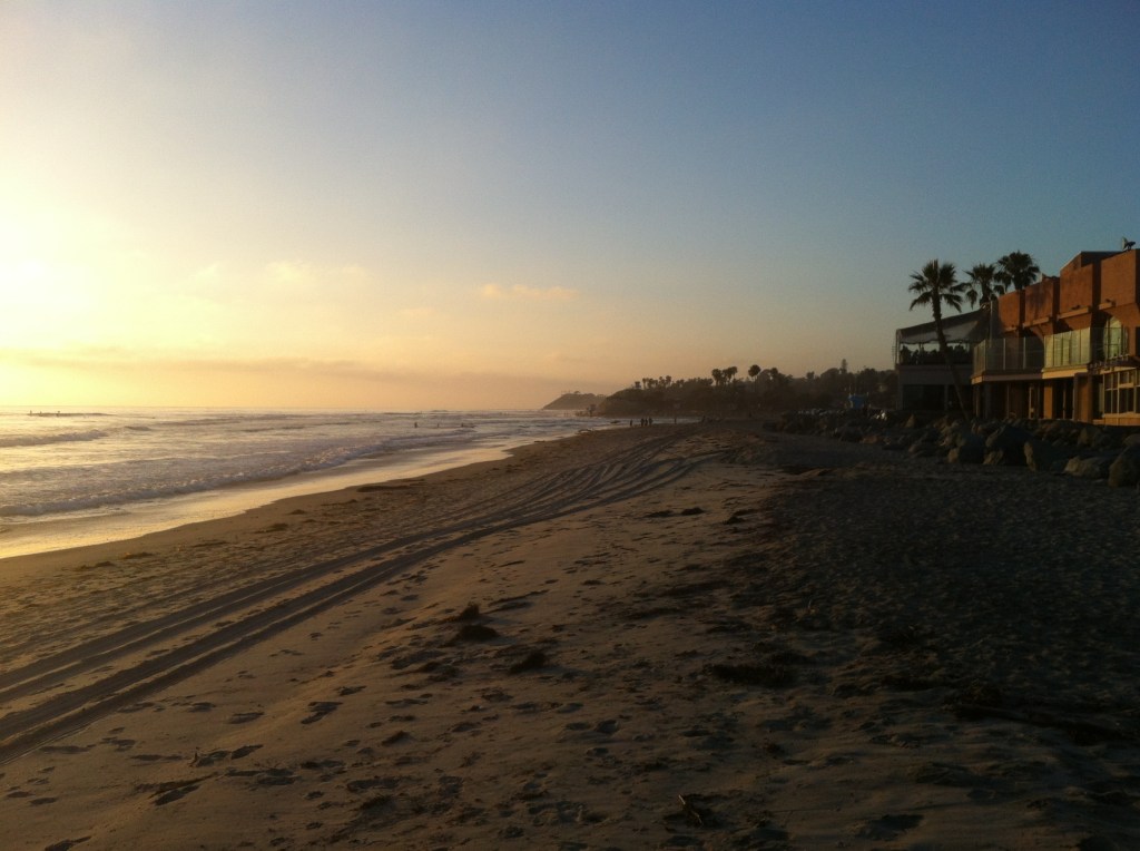 Sunset, sand, surfers.